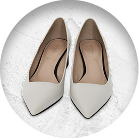 A photo of a pair of smart white leather court shoes with pointed toes.