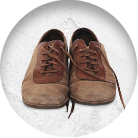 A photo of a pair of well-worn brown suede shoes