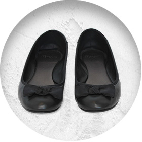 A photo of a pair of black ballet-style pumps.