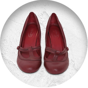 A photo of a pair of deep red high heels with rounded toes.